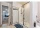 Bathroom with glass shower, stylish tile flooring, and access to the primary bedroom, providing convenience at 36 Ivy Chase Loop, Dallas, GA 30157