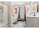 Bright bathroom featuring a glass-enclosed shower, soaking tub, double vanity, and updated fixtures at 36 Ivy Chase Loop, Dallas, GA 30157