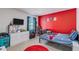 Colorful bedroom with a red accent wall, playful decor, and comfortable furnishings at 36 Ivy Chase Loop, Dallas, GA 30157