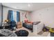 Cozy bedroom with a sports theme, featuring a desk, comfortable seating, and natural light at 36 Ivy Chase Loop, Dallas, GA 30157