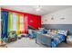 Shared bedroom with two beds, bright rainbow curtains, and playful wall decor, creating a fun space at 36 Ivy Chase Loop, Dallas, GA 30157