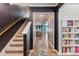 Inviting foyer featuring hardwood floors, a staircase, dark accent walls, white trim, and a built-in bookcase at 36 Ivy Chase Loop, Dallas, GA 30157