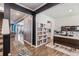 Open foyer featuring hardwood floors, a staircase, a built-in bookcase, a desk, and an adjacent dining area at 36 Ivy Chase Loop, Dallas, GA 30157