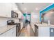 Galley kitchen featuring stainless appliances, granite countertops, and an open concept design at 36 Ivy Chase Loop, Dallas, GA 30157