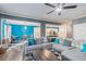 Bright living room featuring hardwood floors, an open layout, a fireplace, a dining area, and a partial kitchen view at 36 Ivy Chase Loop, Dallas, GA 30157