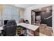 Bright office space featuring a desk, ample natural light, hardwood floors, a built-in coat rack, and neutral tones at 36 Ivy Chase Loop, Dallas, GA 30157
