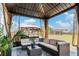 Comfortable patio area with a wicker sofa, rug, and patio umbrella overlooking the backyard at 36 Ivy Chase Loop, Dallas, GA 30157