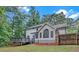 Backyard exterior view of home featuring a deck, lawn and mature trees at 63 Lakeview Ln, Stockbridge, GA 30281