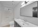 Bathroom showcasing dark vanity, stylish mirror, and shower-tub combo at 63 Lakeview Ln, Stockbridge, GA 30281