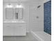 Modern bathroom featuring dual sinks and a shower with luxurious tile accents at 63 Lakeview Ln, Stockbridge, GA 30281