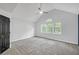 A bedroom featuring a vaulted ceiling, neutral paint, and multiple windows at 63 Lakeview Ln, Stockbridge, GA 30281