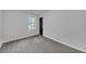 Neutral bedroom featuring neutral carpet, natural light and a black door at 63 Lakeview Ln, Stockbridge, GA 30281