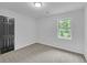 Neutral bedroom featuring neutral carpet, natural light and a black door at 63 Lakeview Ln, Stockbridge, GA 30281