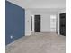 Spacious bedroom with carpet, fresh paint, and multiple doors at 63 Lakeview Ln, Stockbridge, GA 30281