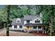 Charming two-story home with a welcoming front porch and a beautifully landscaped yard surrounded by mature trees at 63 Lakeview Ln, Stockbridge, GA 30281
