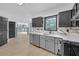 Stylish kitchen with gray and black cabinets, stainless steel appliances, and sleek countertops and backsplash at 63 Lakeview Ln, Stockbridge, GA 30281