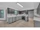 Modern kitchen featuring gray lower cabinets, dark upper cabinets, stainless steel appliances, and stone countertops at 63 Lakeview Ln, Stockbridge, GA 30281