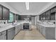 Beautiful kitchen featuring black and gray cabinets, stainless steel appliances, and stylish marble-look countertops at 63 Lakeview Ln, Stockbridge, GA 30281