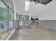 Light-filled sun room with lots of windows offering beautiful views, wood floors and a view into the kitchen at 63 Lakeview Ln, Stockbridge, GA 30281