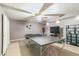 Spacious basement recreation room with ping pong table, television, and ceiling fan at 9444 Lakeview Ct, Douglasville, GA 30135