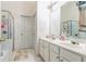 Clean bathroom with a double vanity, a glass-enclosed shower, and tiled flooring at 9444 Lakeview Ct, Douglasville, GA 30135