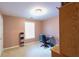 Cozy bedroom with soft pink walls, a window, and a minimalist decor style at 9444 Lakeview Ct, Douglasville, GA 30135