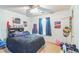 Cozy bedroom features carpet flooring, ceiling fan and natural light from the single window at 9444 Lakeview Ct, Douglasville, GA 30135