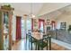 Bright dining area with hardwood floors, a wooden table, and a view of the living room at 9444 Lakeview Ct, Douglasville, GA 30135