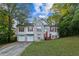 Charming two-story home featuring a brick facade, red shutters, and a well-manicured front lawn at 9444 Lakeview Ct, Douglasville, GA 30135