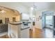 Open-concept kitchen with a bar, white cabinetry, and hardwood flooring, seamlessly connecting to the living area at 9444 Lakeview Ct, Douglasville, GA 30135