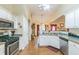 Well-lit kitchen featuring stainless steel appliances, white cabinets, and hardwood floors at 9444 Lakeview Ct, Douglasville, GA 30135