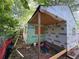 The framed home is being built in a wooded lot, showing framing and building supplies at 1106 Donnelly Sw Ave, Atlanta, GA 30310