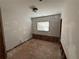 Bedroom awaiting renovation, featuring fresh plaster, window, and original hardwood floors needing refinishing at 1106 Donnelly Sw Ave, Atlanta, GA 30310