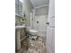 Bathroom with a sink, toilet, bathtub with shower, and unique tiled floors at 1988 Greensferry Gln, Lawrenceville, GA 30043