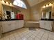 Relaxing bathroom with jacuzzi tub, dual sinks, and bright lighting at 1988 Greensferry Gln, Lawrenceville, GA 30043