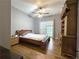Bedroom with hardwood floors, vaulted ceilings, with a bed and wooden storage furniture at 1988 Greensferry Gln, Lawrenceville, GA 30043