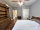 Bedroom with hardwood floors, ceiling fan, bed, dresser, and closet for optimal storage at 1988 Greensferry Gln, Lawrenceville, GA 30043