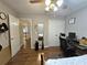 Neutral bedroom features hardwood floors, ceiling fan, and workspace with desk and chair at 1988 Greensferry Gln, Lawrenceville, GA 30043