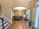 Elegant dining room with an arched doorway, chandelier, and large window at 1988 Greensferry Gln, Lawrenceville, GA 30043