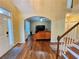 Welcoming entryway with hardwood floors, staircase, and an arched doorway at 1988 Greensferry Gln, Lawrenceville, GA 30043