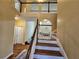 Bright entryway with hardwood steps, white banisters, and an open view to the living space at 1988 Greensferry Gln, Lawrenceville, GA 30043