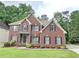 Charming two-story brick home with a well-maintained lawn and mature trees at 1988 Greensferry Gln, Lawrenceville, GA 30043