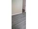 Neutral room featuring gray laminate flooring and white trim at 1988 Greensferry Gln, Lawrenceville, GA 30043