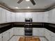 Well-lit kitchen with stainless steel appliances and white cabinets and plenty of counter space at 1988 Greensferry Gln, Lawrenceville, GA 30043