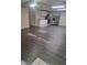 Open-concept kitchen and living area with modern appliances and stylish gray wood-look flooring at 1988 Greensferry Gln, Lawrenceville, GA 30043