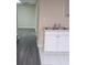 Corner view of kitchenette with double sink, white cabinets, and gray laminate flooring at 1988 Greensferry Gln, Lawrenceville, GA 30043