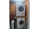 Stacked washer and dryer with pegboard, electrical outlets and water filtration system at 1988 Greensferry Gln, Lawrenceville, GA 30043