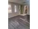 Sunlit living area with modern gray flooring, white trim, and neutral walls at 1988 Greensferry Gln, Lawrenceville, GA 30043