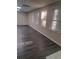 Bright and airy living area with gray laminate flooring and large windows at 1988 Greensferry Gln, Lawrenceville, GA 30043