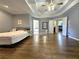 Spacious main bedroom featuring tray ceilings, hardwood floors, and two closets at 1988 Greensferry Gln, Lawrenceville, GA 30043
